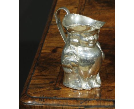 A George V silver novelty cream pitcher, as a toby jug, modelled after a Staffordshire pottery model, scroll handle, gilt int