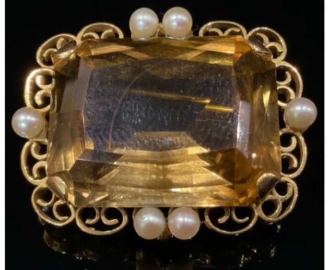 A rectangular smoky quartz and pearl brooch, stamped '9ct', the facet cut canted rectangular stone 25mm wide, 21mm high, claw