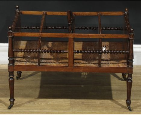 A 19th century Colonial four section Canterbury, bobbin-turned side rails, wicker base, turned legs, brass casters, 44cm high