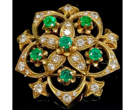 A diamond, emerald and 18ct gold flower head brooch, the five openwork petals diamond set and centered with circular faceted 