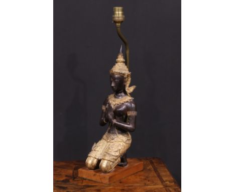 A mid-20th century Thai figural table lamp, with a parcel gilt kneeling Tara figure, hardwood base, 42cm to base of fitting 