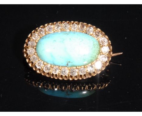 An Edwardian oval diamond and turquoise brooch, the large central cabochon stone within a border of 23 diamonds, 2.9cm wide, 