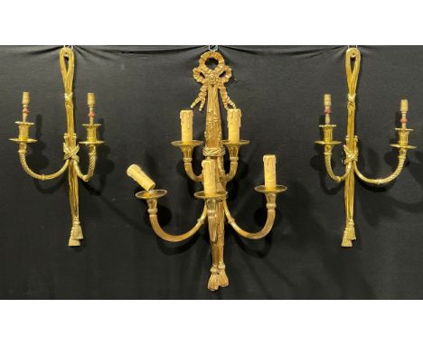 A harlequin garniature of Louis XVI style brass five-light wall sconces, ribbon crestings, the largest 72cm high 