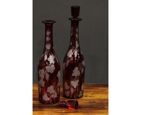 A pair of Bohemian ruby flashed glass decanters, etched with spiralling fruiting vine, 35cm high, c.1880 