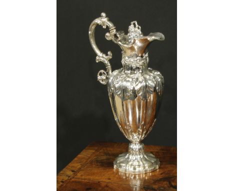 A Victorian silver fluted pedestal wine ewer, profusely chased with fruiting vine, hinged cover, 32.5cm high, Henry Wilkinson