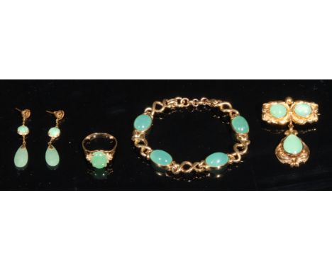 A composed suite of 18ct and 15ct gold jewellery set with polished jade , comprising, an 18ct gold ring, set with a central p