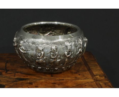 A Burmese silver circular bowl, interestingly repousse chased with a meeting between Assyrian and Indian Sub-Continental figu