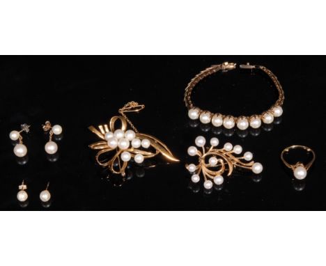 A composed suite of 9ct and 14ct cultured pearl jewellery, comprising a 14k gold ring, size Q, 3.4g; a 14k gold brooch, 5cm, 