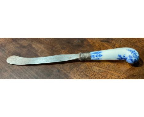 A Bow porcelain knife handle, pistol grip, painted in underglaze blue with foliate tendrils and scrolls, in the manner of Sai