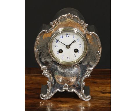 An Edwardian silver cartouche shaped mantel clock, 7.5cm circular enamel dial inscribed with Arabic numerals, twin-winding ho