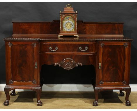 A George II Revival mahogany serving table or sideboard, in the Irish taste, the back centred by a boldly pierced and carved 