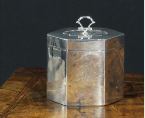 An Edwardian silver lozenge shaped tea caddy, of George III design, hinged cover with batwing patera, axehead handle, 9.5cm w