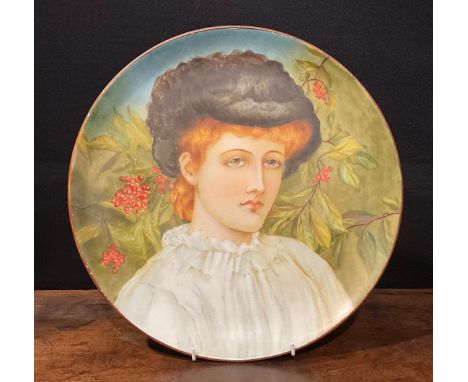 An Aesthetic Movement circular charger, Study of a Girl, painted with a portrait of an auburn-haired maiden before rowan, 36.