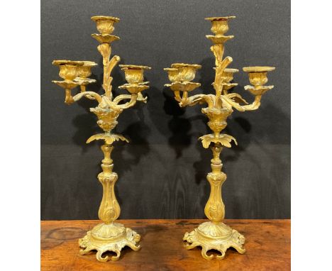 A pair of 19th century gilt metal five-light candelabra, cast throughout with acanthus in the Rococo taste, 47cm high, c.1900