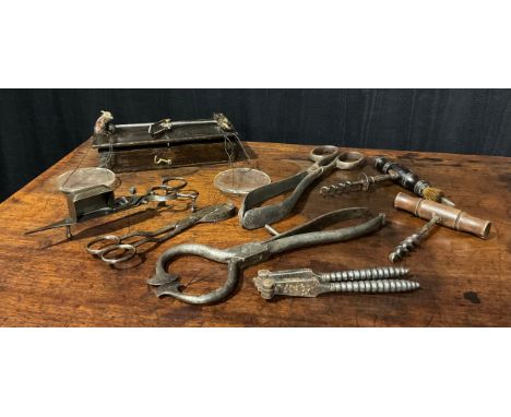 A pair of George III steel sugar cutters, 23.5cm long, early 19th century; gold scales; candle snuffers; cork screws; nut cra