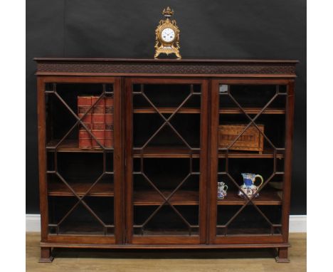A Chippendale Revival mahogany low library bookcase, rectangular top above three glazed doors enclosing adjustable shelves, b
