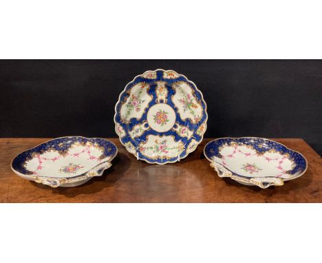 A pair of Worcester shell shaped dessert dishes, painted with floral bouquet and pink floral swags, cobalt blue border picked