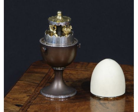 Anthony Gordon Elson (Bn.1935)- an Elizabeth II silver surprise egg, enclosing a gilt carousel, 11cm high, numbered 200/97, L