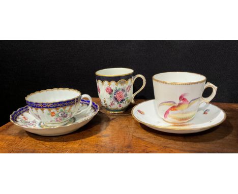 A Worcester fluted teacup and saucer, circular cartouches painted with lakeside scenes, edged with a pattern of overlapping t