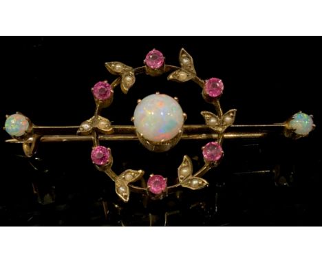 An Edwardian opal, ruby, seed peal and 9ct gold bar brooch, the central cabochon opal within a wreath of pink rubies and peal