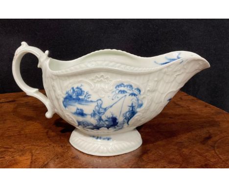 A first period Worcester blue and white sauceboat, the whole press moulded and painted with Chinese fishermen amongst trees a