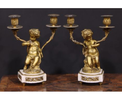 A pair of 19th century French bronze figural two-light candelabra, after Clodion (1738 - 1814), signed in the maquette, cast 