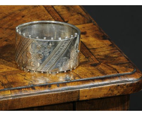 A Victorian Aesthetic Movement silver hinge bangle, 6.5cm wide, G A R, Birmingham, 1884 