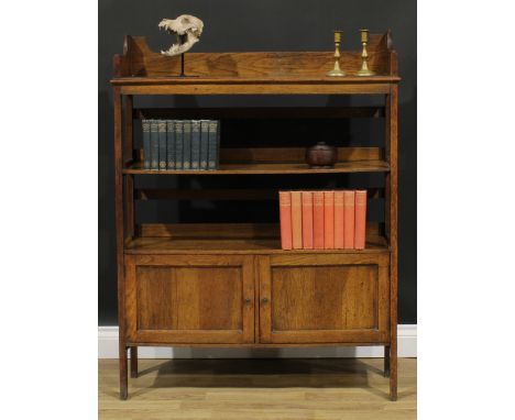 An Arts &amp; Crafts oak bookcase, three-quarter gallery above open shelves and a pair of panel doors, stile legs, RD 525677,