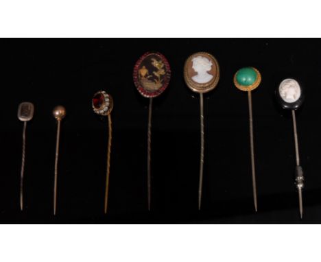 An 19th century stick pin, urn decoration, surrounded with ruby chips; two cameo pins, others (7) 