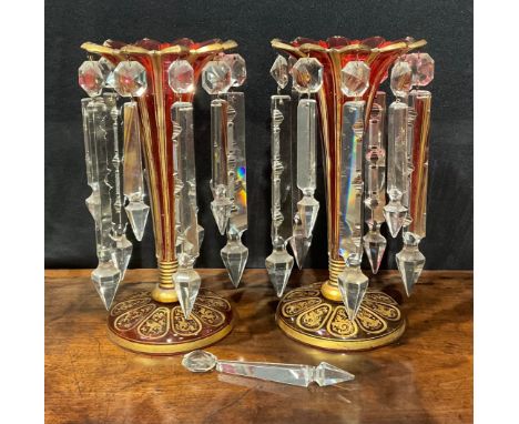 A pair of 19th century Bohemian ruby flashed and gilt table lustres, of trumpet form with shaped cut rim, clear glass prismat