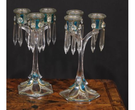 A pair of 19th century pressed glass three-light candle lustres, with blue-flash panels picked out with scrolls in gilt and w