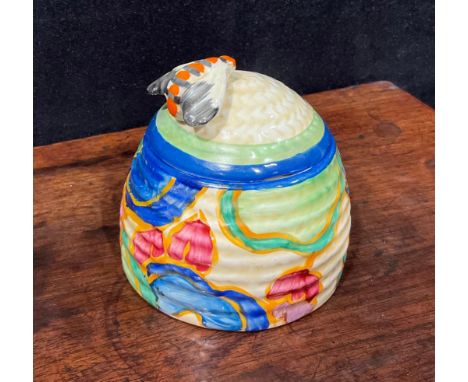 A Clarice Cliff Bizarre Fantasque Blue Chintz pattern ribbed honey pot and cover, the moulded basketweave cover with bee knop