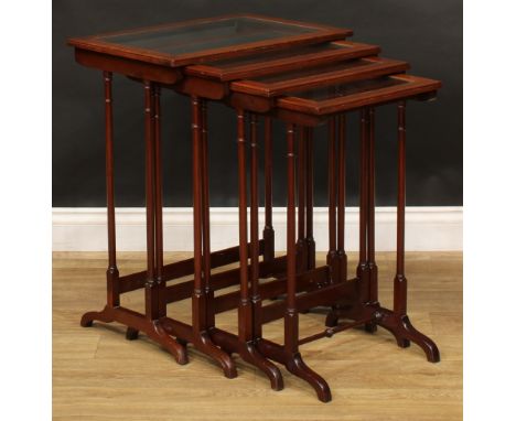 A set of Edwardian mahogany quartetto tables, each plateau with inset glass panel, outlined throughout with chequered stringi