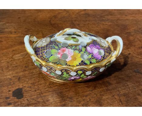A Spode basket shaped violeteer or pot pourri vase and cover, finely painted in coloured enamels with flowers and leaves, on 