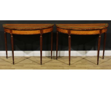 A pair of Sheraton period tulipwood crossbanded satinwood and painted demilune card tables, each with a hinged top enclosing 