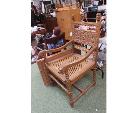 Heavily carved Throne chair with caned seat and Lions head arms over bobbin turned stretcher 