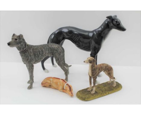 A POTTERY GREYHOUND, 20cm high together with; a rough coated painted resin long dog, a 19th century ceramic reclining long do