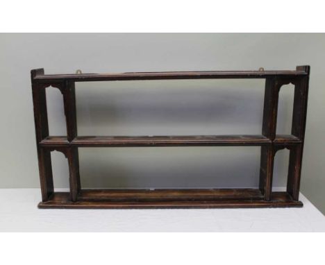 A 19TH CENTURY OAK WALL SHELF RACK with two moulded niches to the ends, 118cm wide x 61cm high 