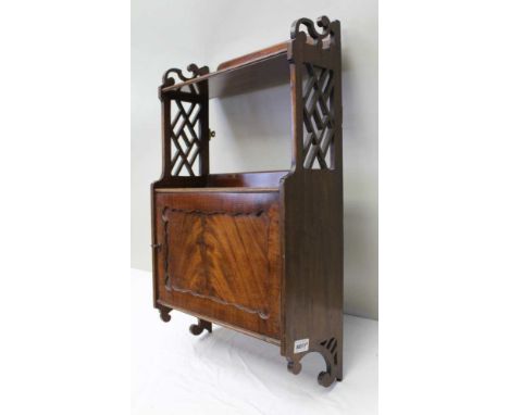 A REGENCY DESIGN MAHOGANY WALL CABINET, the top shelf having pierced sides, with cupboard to base, 43cm wide 