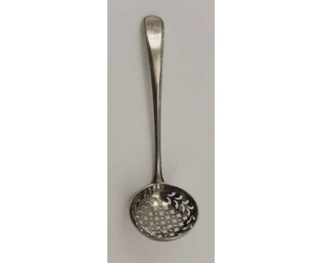 GEORGE SMITH III AN EARLY 18TH CENTURY SILVER SIFTING LADLE, having beaded edge handle, the terminal engraved with a Heraldic