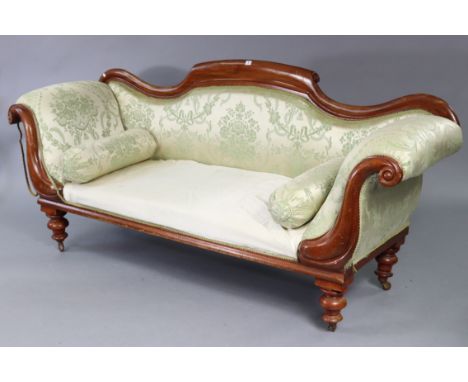 A Victorian mahogany-frame three-seater scroll-end settee with shaped back, (requires reupholstery), &amp; on short turned le
