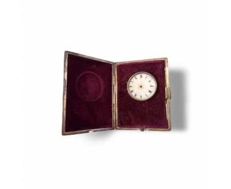 A silver engine turned travel clock