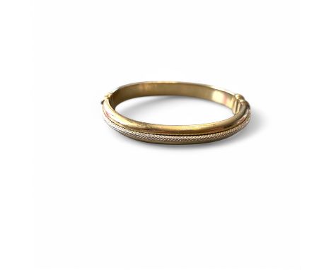 9ct yellow and white gold ladies bangle- solid click shut 20.4 grams. Rope detailing in white gold on yellow. (missing safety