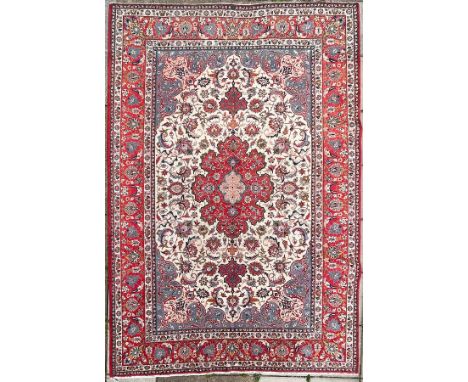 A large Isfahan carpet, Central Persia, the ivory field centred by a raspberry red medallion and with sky blue spandrels, fra