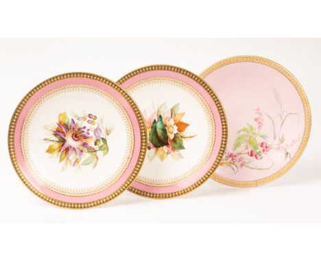 A pair of Royal Worcester plates, each painted with a flower study within pink, black and gilt border with white enamel 'pear