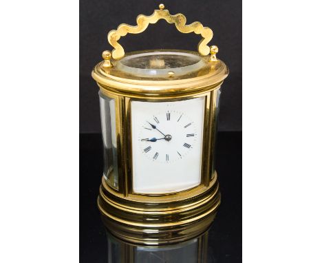 A French brass repeating carriage clock, early 20th Century, oval corniche case, white enamel Roman dial, gong striking mecha