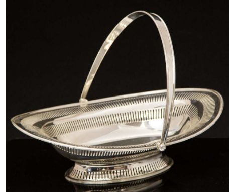 A George V silver bread basket, Neoclassical lozenge form with swing handle and pierced double banding and fluted border, the