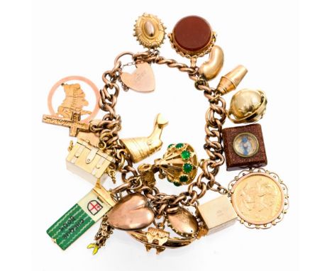 An Edwardian period 9ct gold charm bracelet with padlock fastener and 20 assorted charms(some charms being of later date) to 