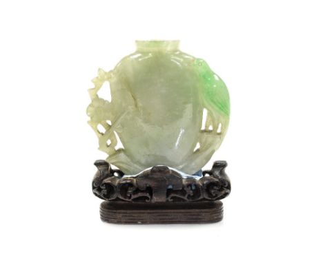 A Chinese pale jade snuff bottle, flat sided carved bird and branch handles, height 5cm, on a wooden stand