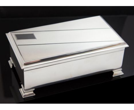 A George V Art Deco silver table cigarette casket, machine engraved, maker S. J. Levi & Co, Birmingham 1932